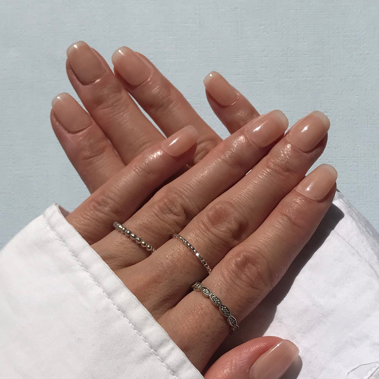 Handmade nude press-on nails in pale oatmeal shade.