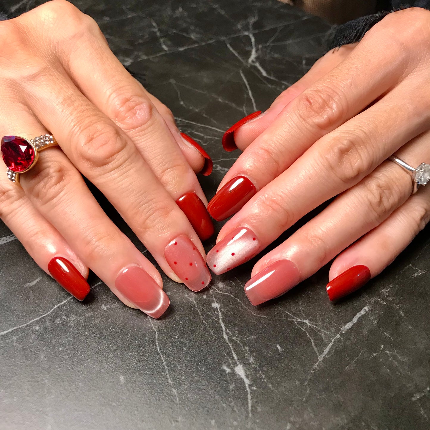 Calm Storm premium handmade press-on nails in burgundy red and pink cat eye design.
