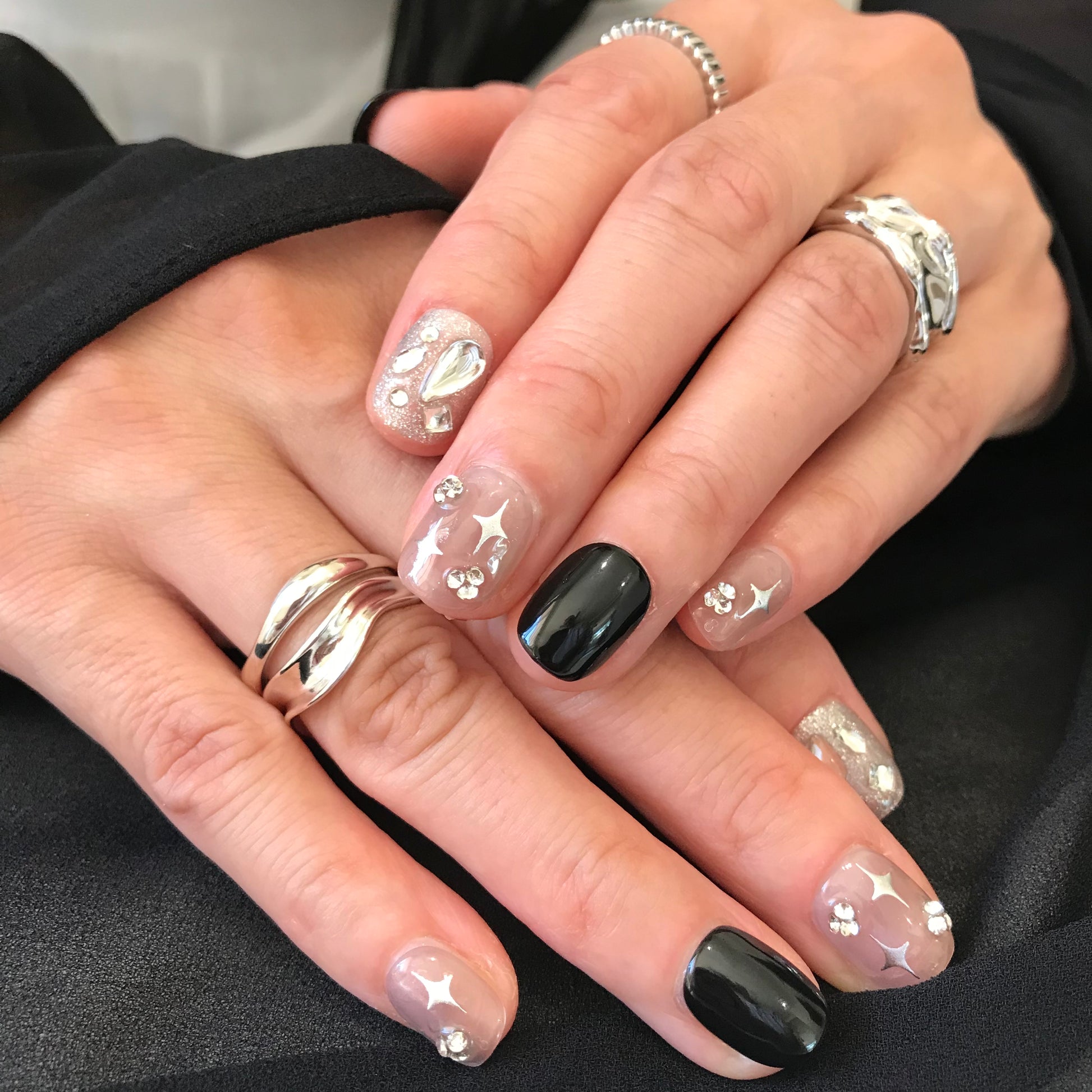 Calm Storm premium handmade press-on nails in black and silver with glitter in extra short. 