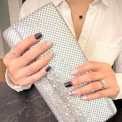 Lifestyle shot of navy blue and silver glitter press-on nails