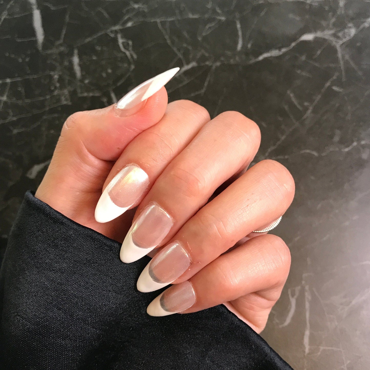 Hand with luxury French press-on nails with Chrome base 