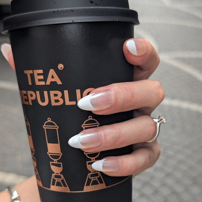 Lifestyle shot of French tip press-on nails with Chrome detail