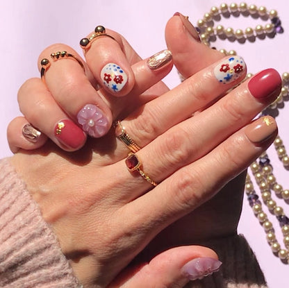 Close up of 3d floral design short round luxury press-on nails