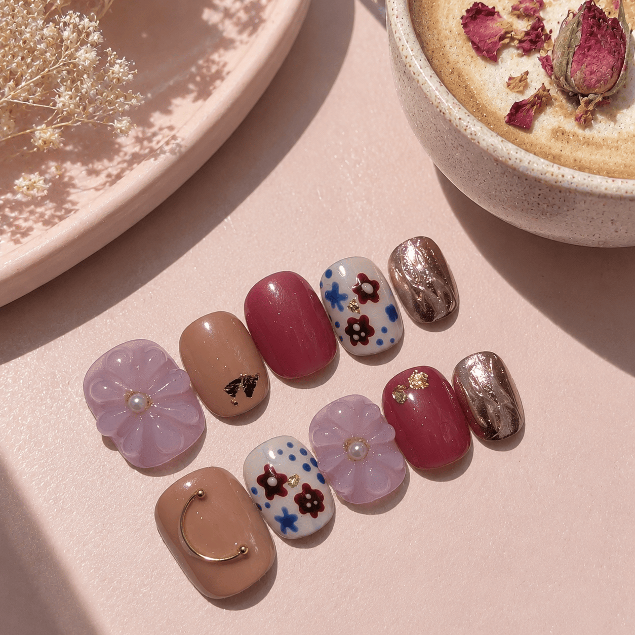Calm Storm handmade press-on nails in pink and gold with 3D floral design and hand painted detail. 