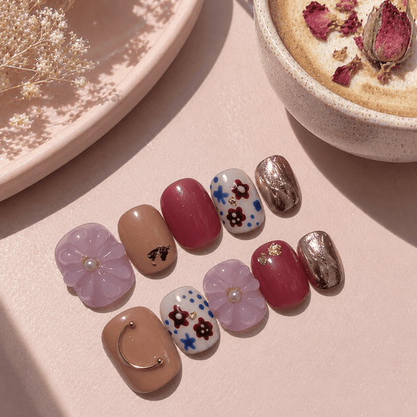 Calm Storm handmade press-on nails in pink and gold with 3D floral design and hand painted detail. 