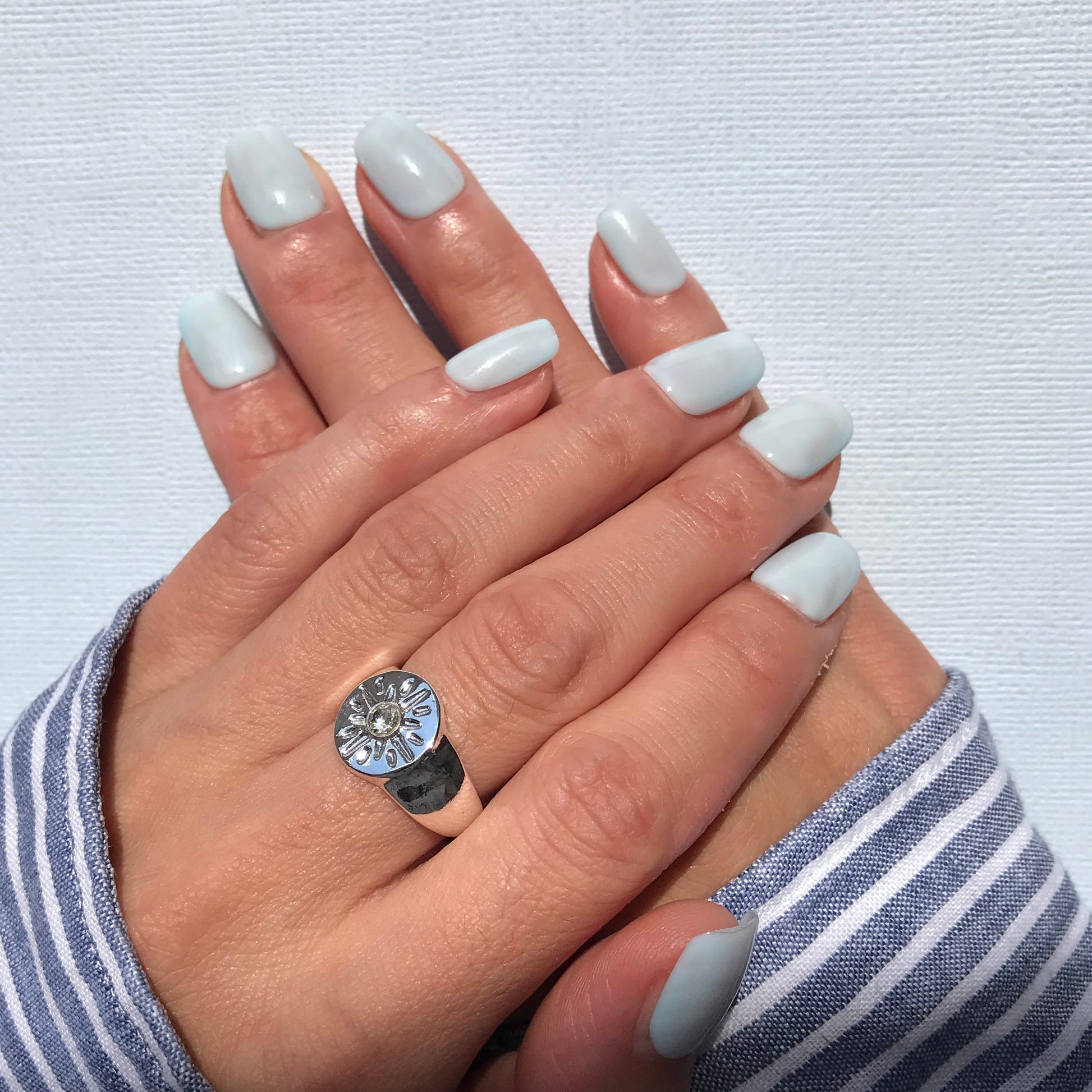 Handmade press-on nails in high gloss milky blue in short square. 