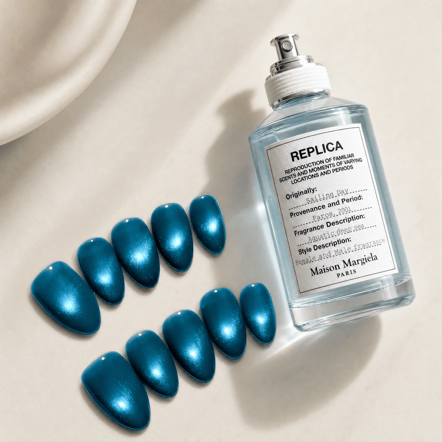 Calm Storm premium handmade press on nails in ocean blue with cat eye design in almond shape. 