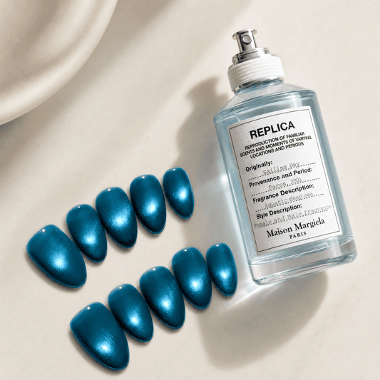 Calm Storm premium handmade press on nails in ocean blue with cat eye design in almond shape. 