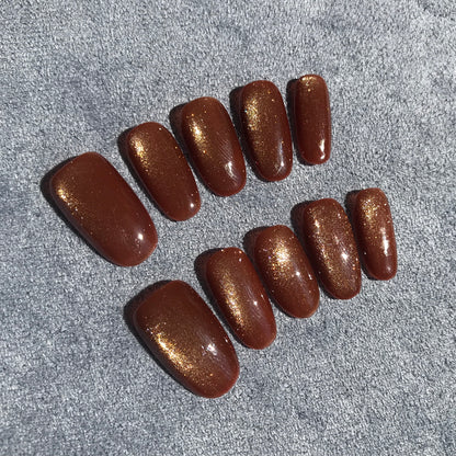 Calm Storm premium press-on nails with a shimmering gold magnetic finish.