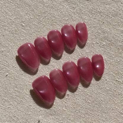 Calm Storm premium handmade pink press-on nails in medium almond with cat eye effect. 