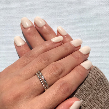 Handmade milky white press-on nails in short square. 