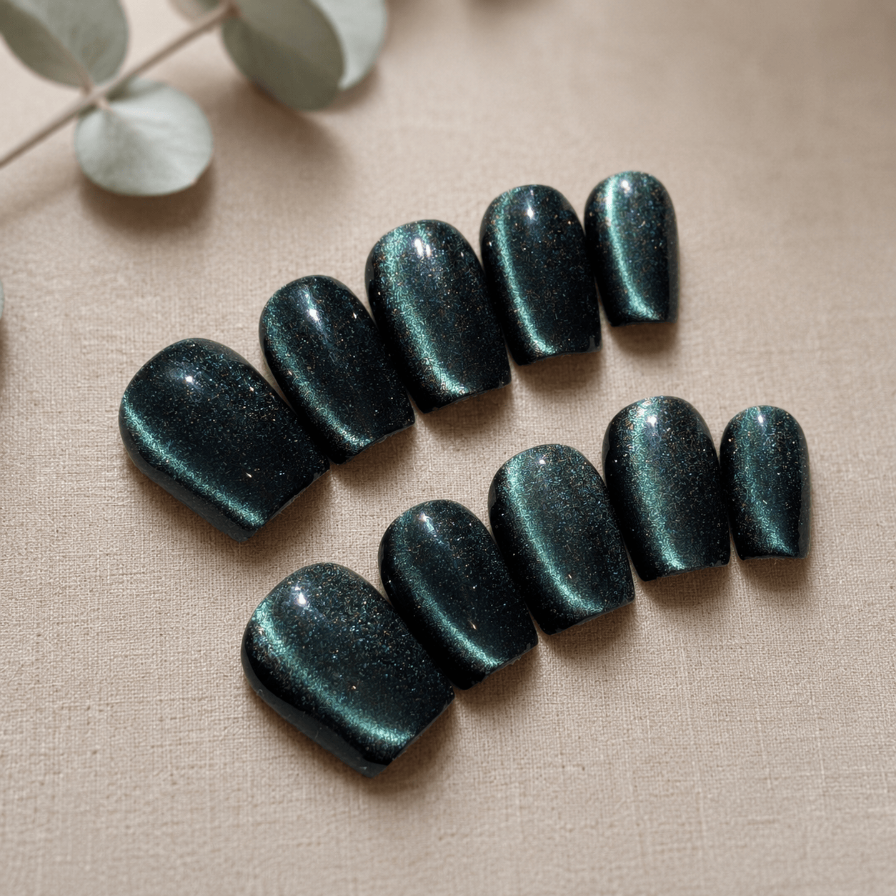 Calm Storm premium handmade press on nails in Emerald green with cat eye design. 