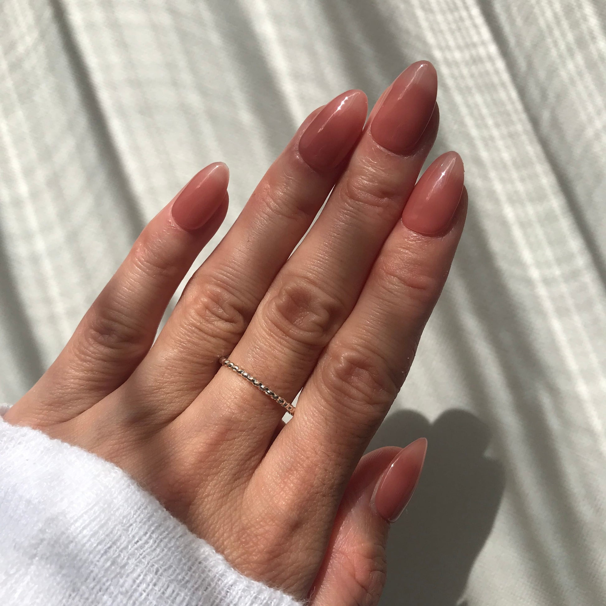 Luxury pink nude press-on nails in short almond.