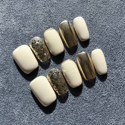 Premium salon quality press-on nails in contrasting white and gold with gold glitter. 