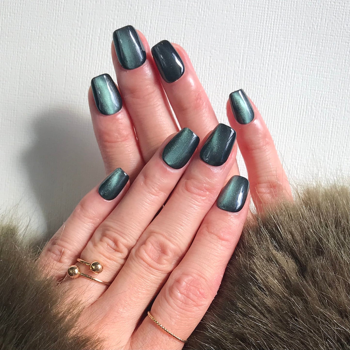Dark green cat eye press-on nails using premium gel.