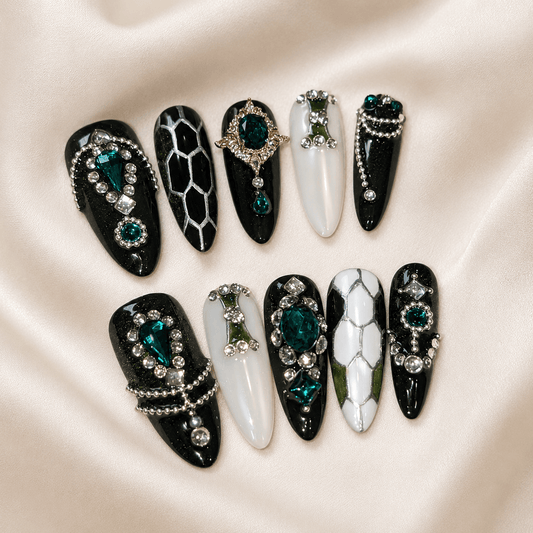 Calm Storm premium press on nails featuring glossy marble designs, embellished with green gemstones and silver bead details.