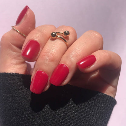 Close up of luxury press-on nails in hot pink in short square. 