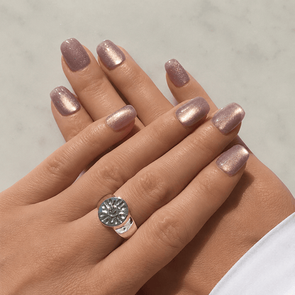 A close up of press-on nails in light lilac with cat eye effect.