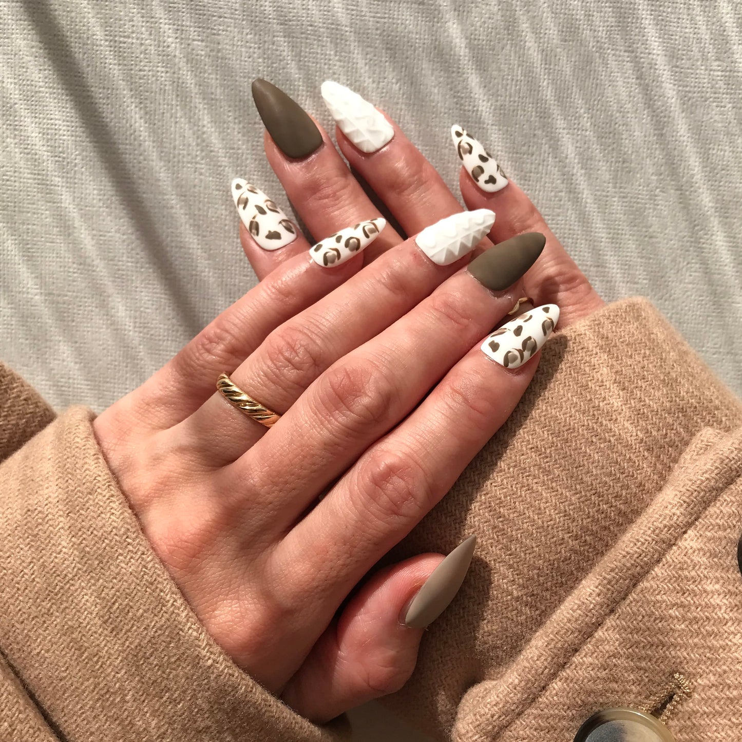 Hand with stylish  press-on nails in matt finish in medium almond shape. 