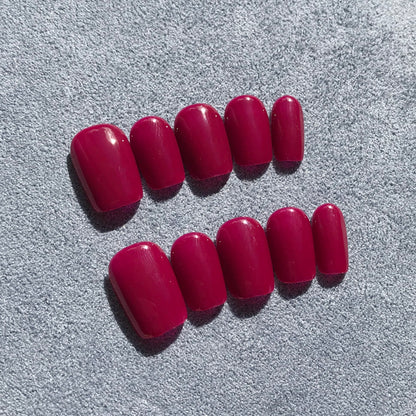 Handmade press-on nails in deep magenta in extra short square. 