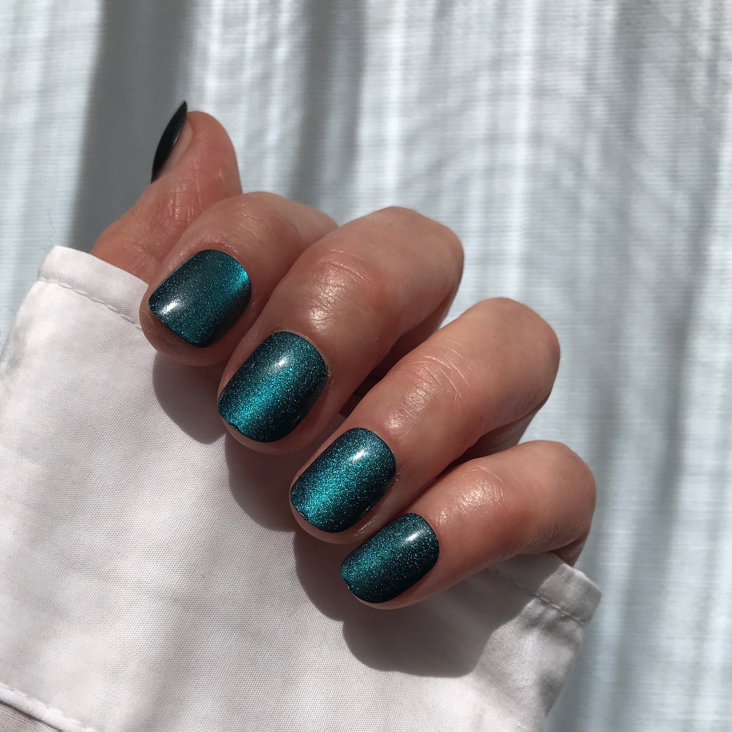 Premium handmade press-on nails in glittery teal in extra short. 