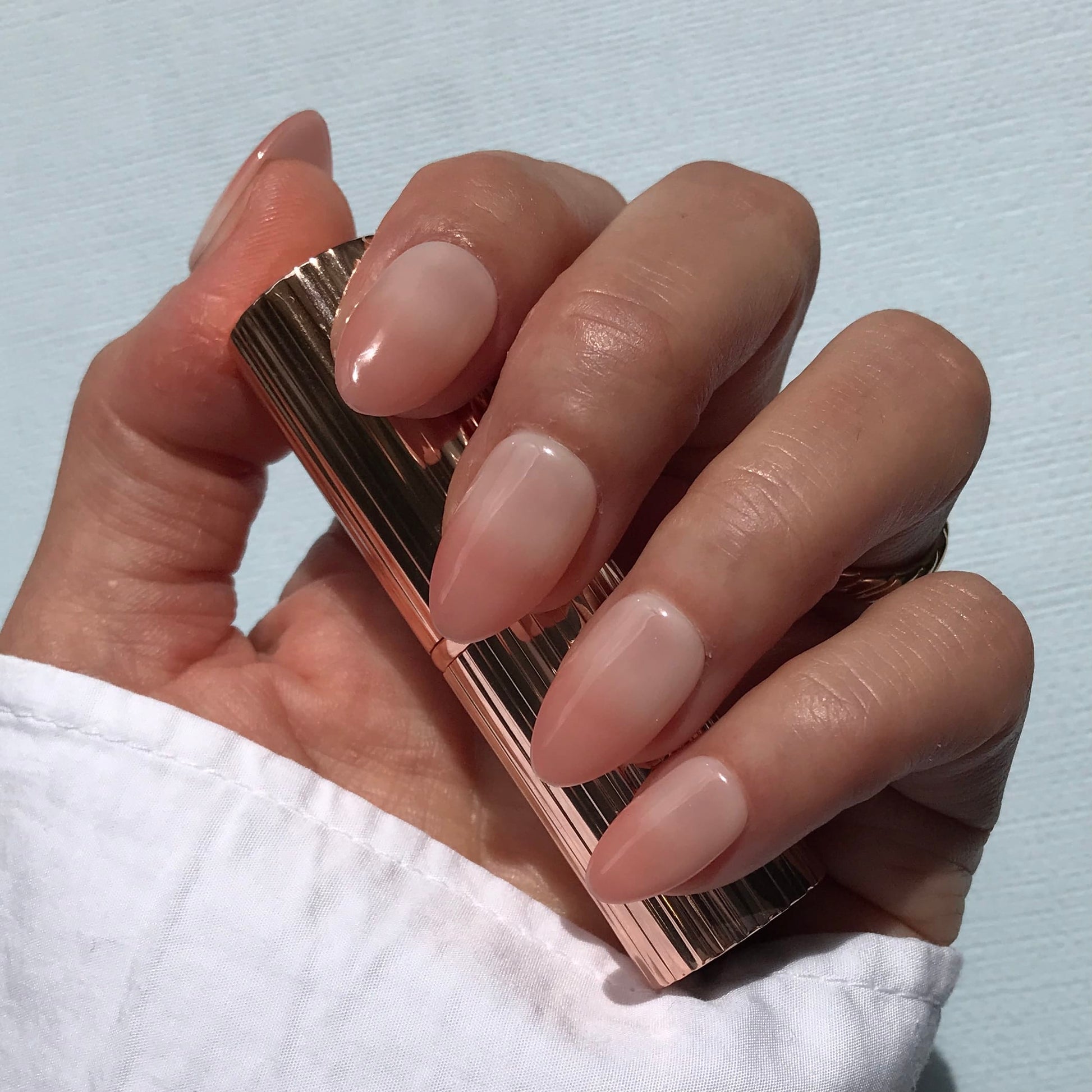 Calm Storm handmade milky nude press-on nails in almond. 