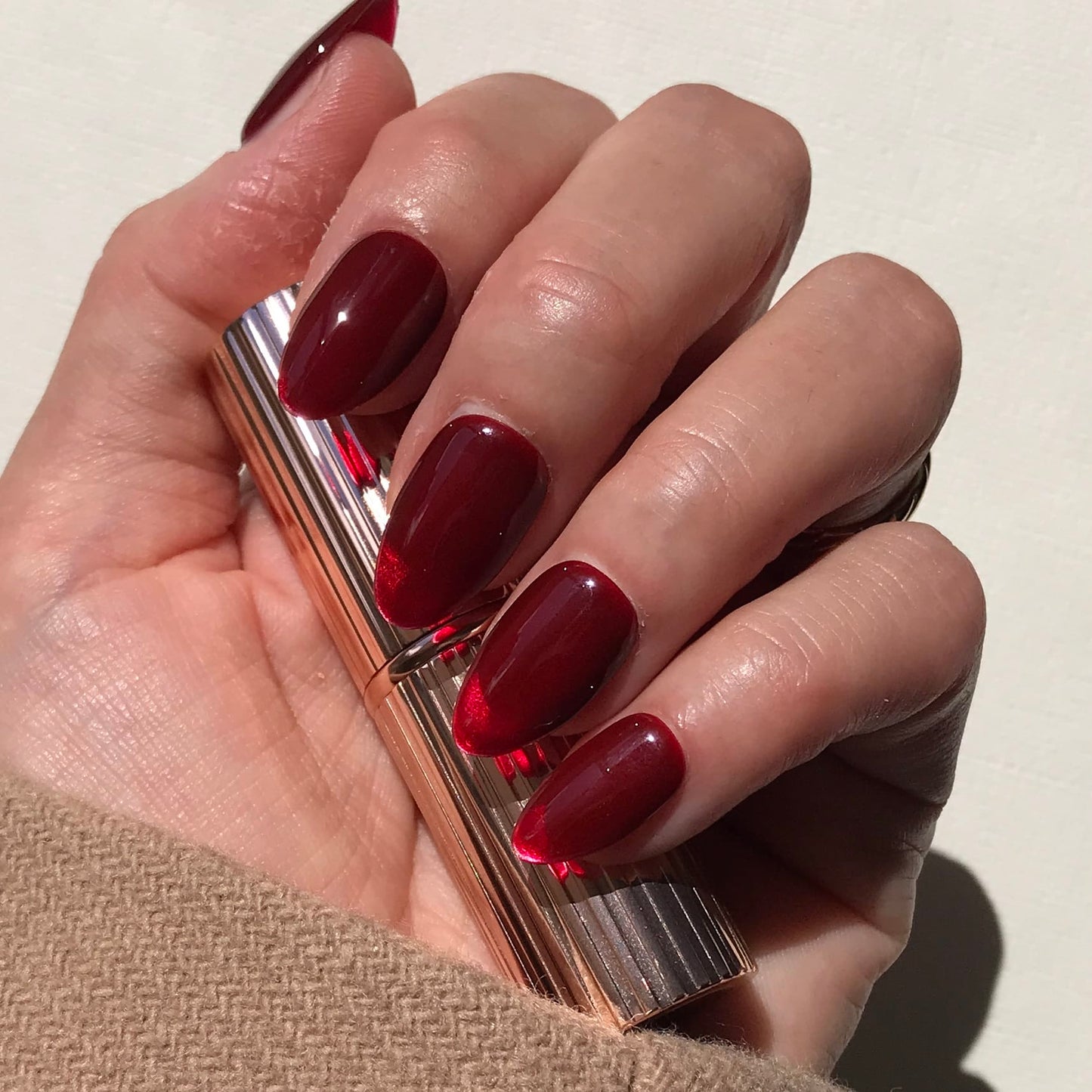Luxury handmade  press-on nails in classic cherry red in medium almond.