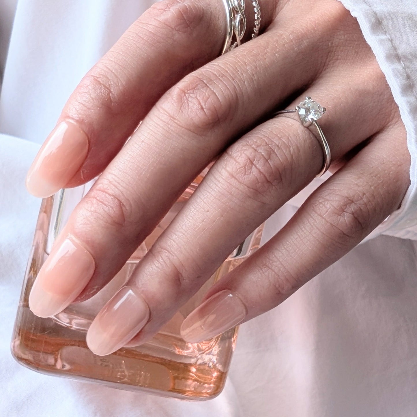 Calm Storm premium handmade press-on nails in pale pink in medium oval. 