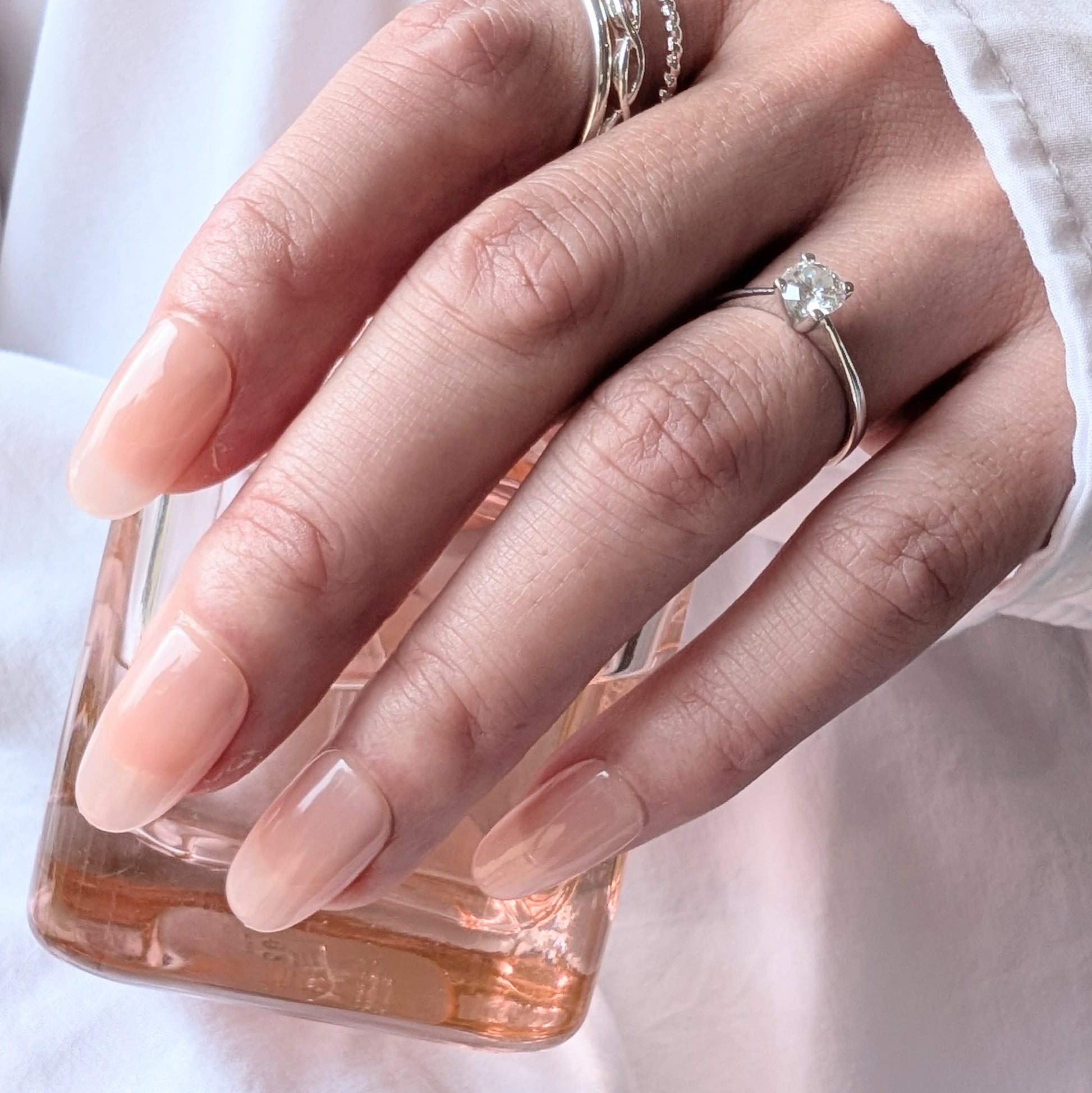 Calm Storm premium handmade press-on nails in pale pink in medium oval. 