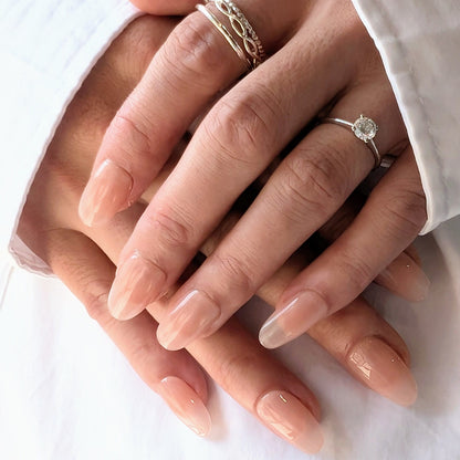 Soft pinky nude press-on nails in natural oval shape.