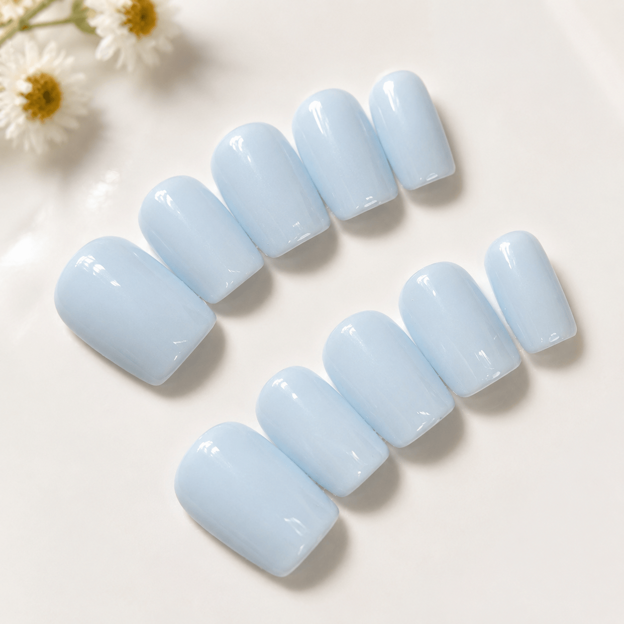 Calm Storm handmade press on nails in pastel blue in square shape.