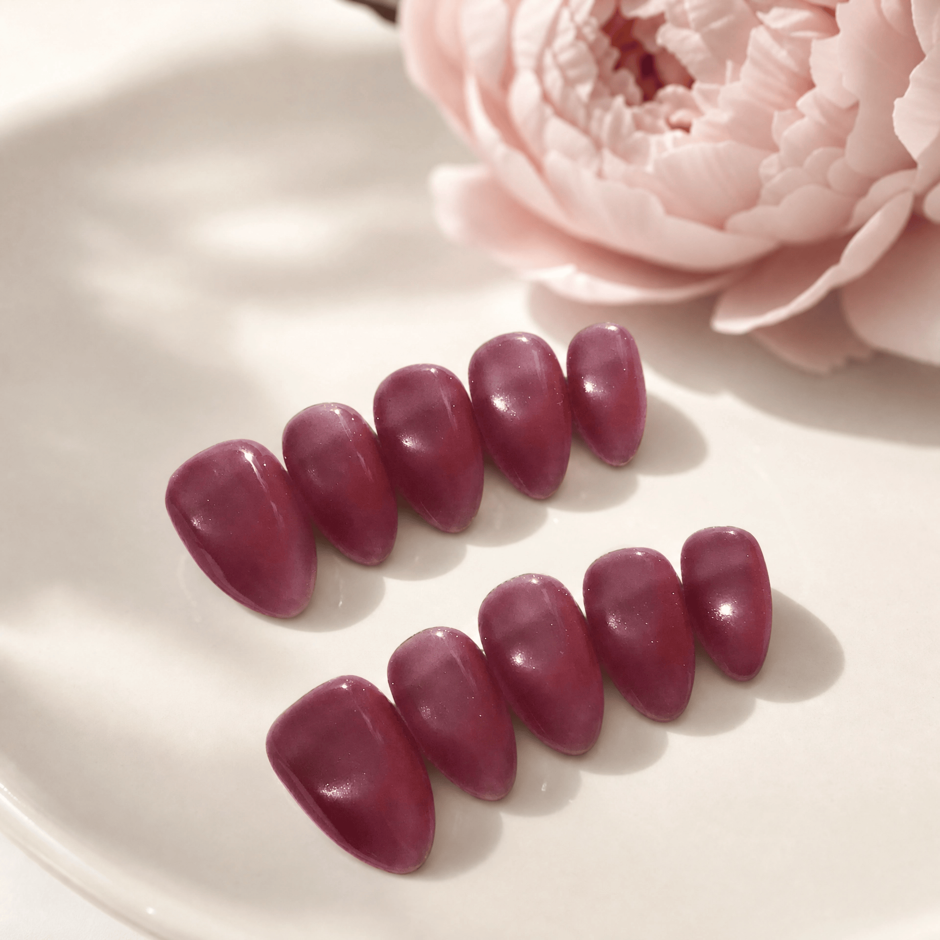 Calm Storm handmade pink purple press on nails with cat eye design in almond shape.