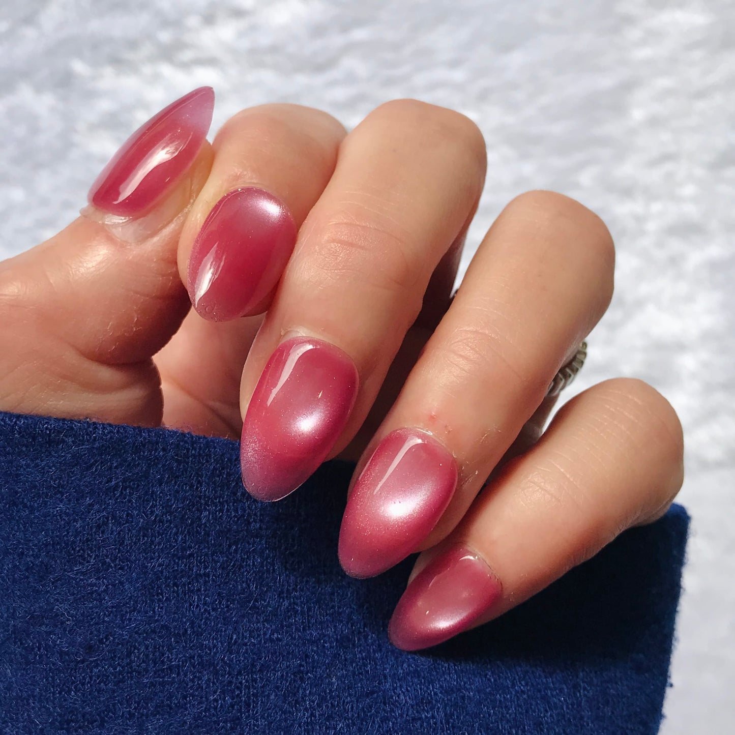 Hand with luxury handmade glittering pink press-on nails.