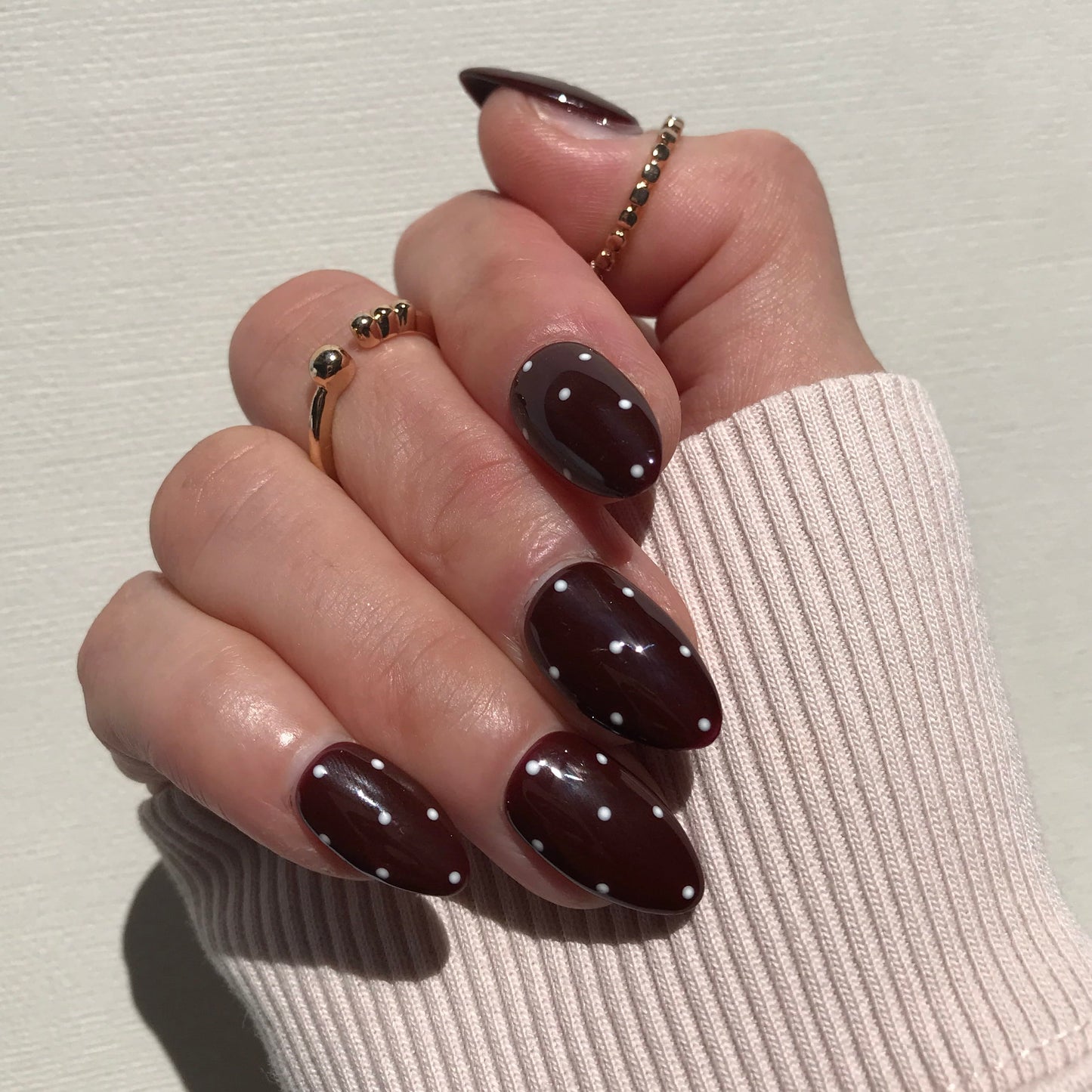 Handmade luxury brown press-on nails with white polka dot.