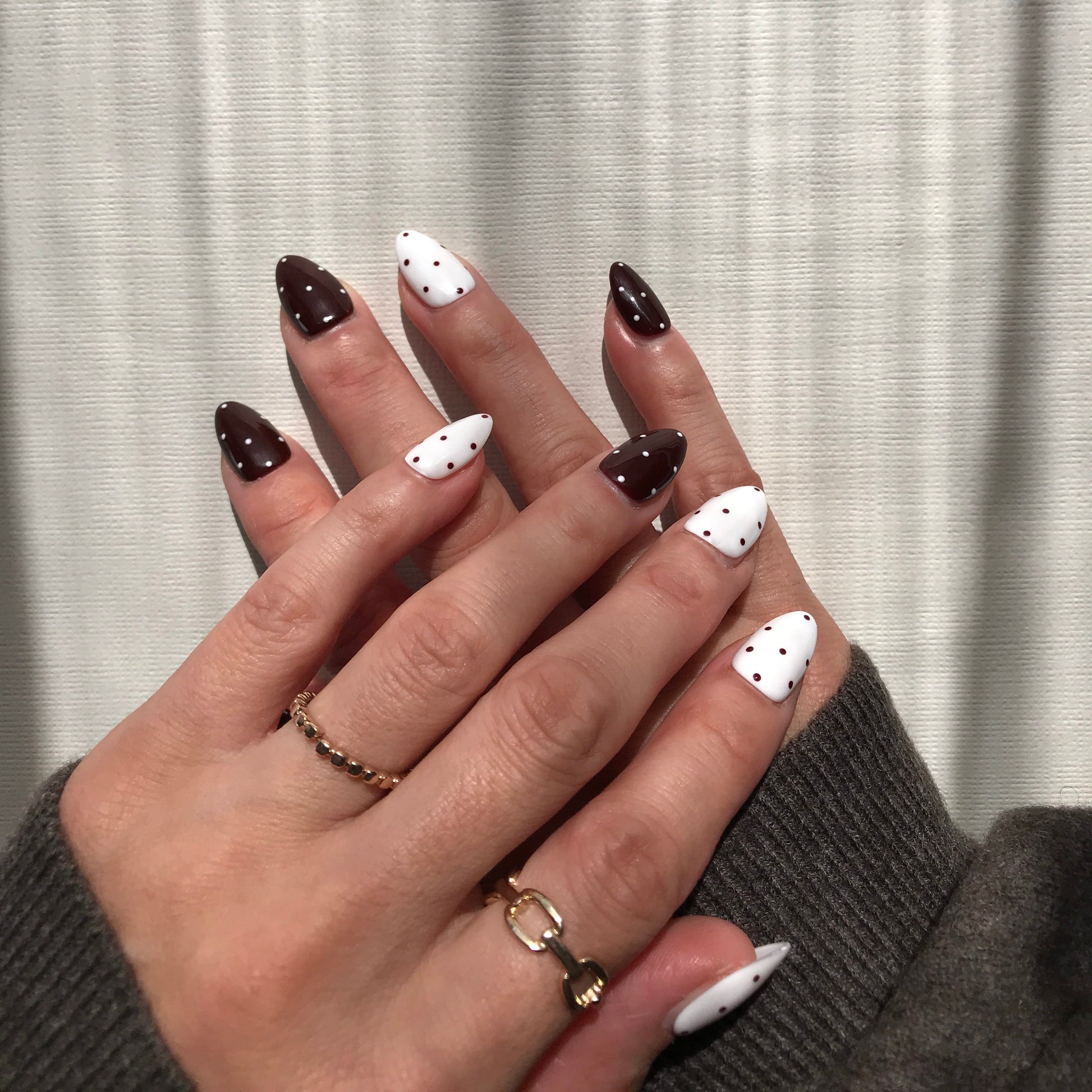 Handmade brown and white polka dot press-on nails.