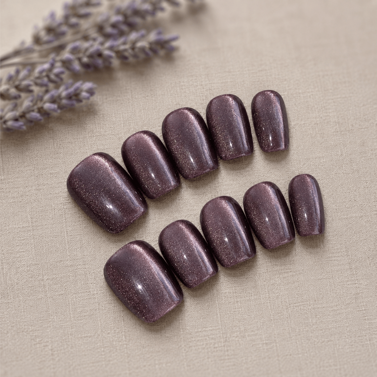 Calm Storm handmade purple press on nails with glittering cat eye design.