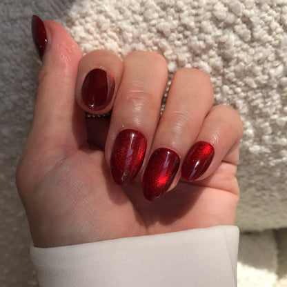 Salon quality press-on nails in red cat eye effect.