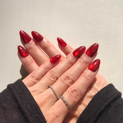 Calm Storm premium press-on nails in bright red cat eye in almond shape. 