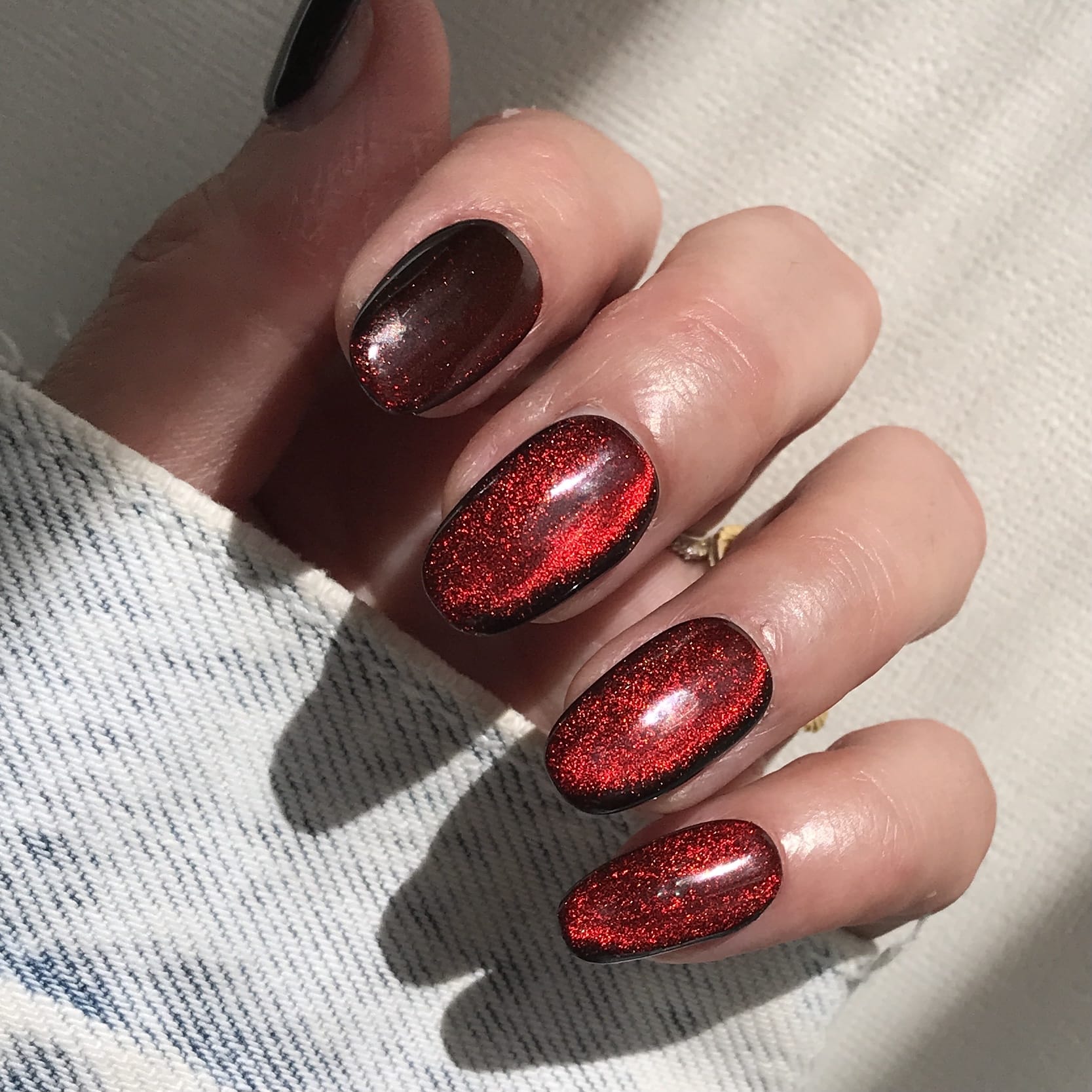 Close up of handmade luxury press-on nails in glittery red. 