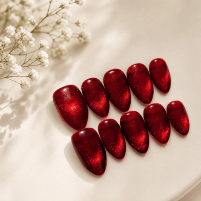 Calm Storm premium handmade press on nails in red with cat eye design in almond shape.