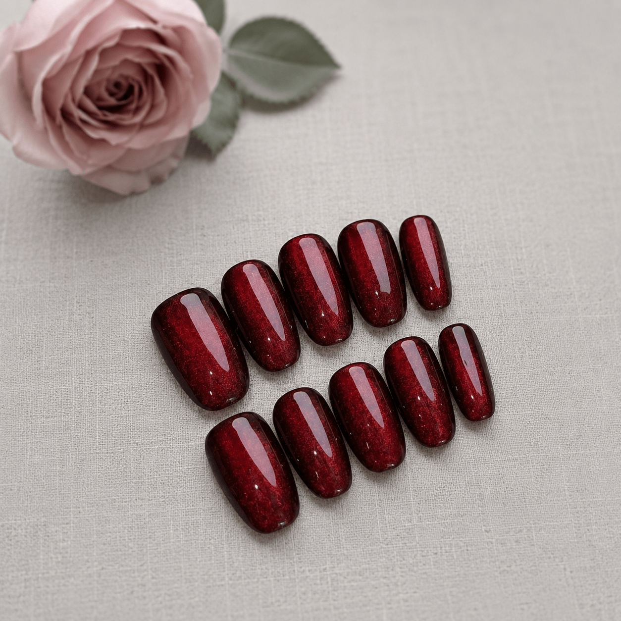 Calm Storm handmade press on nails in red with glittering cat eye design. 