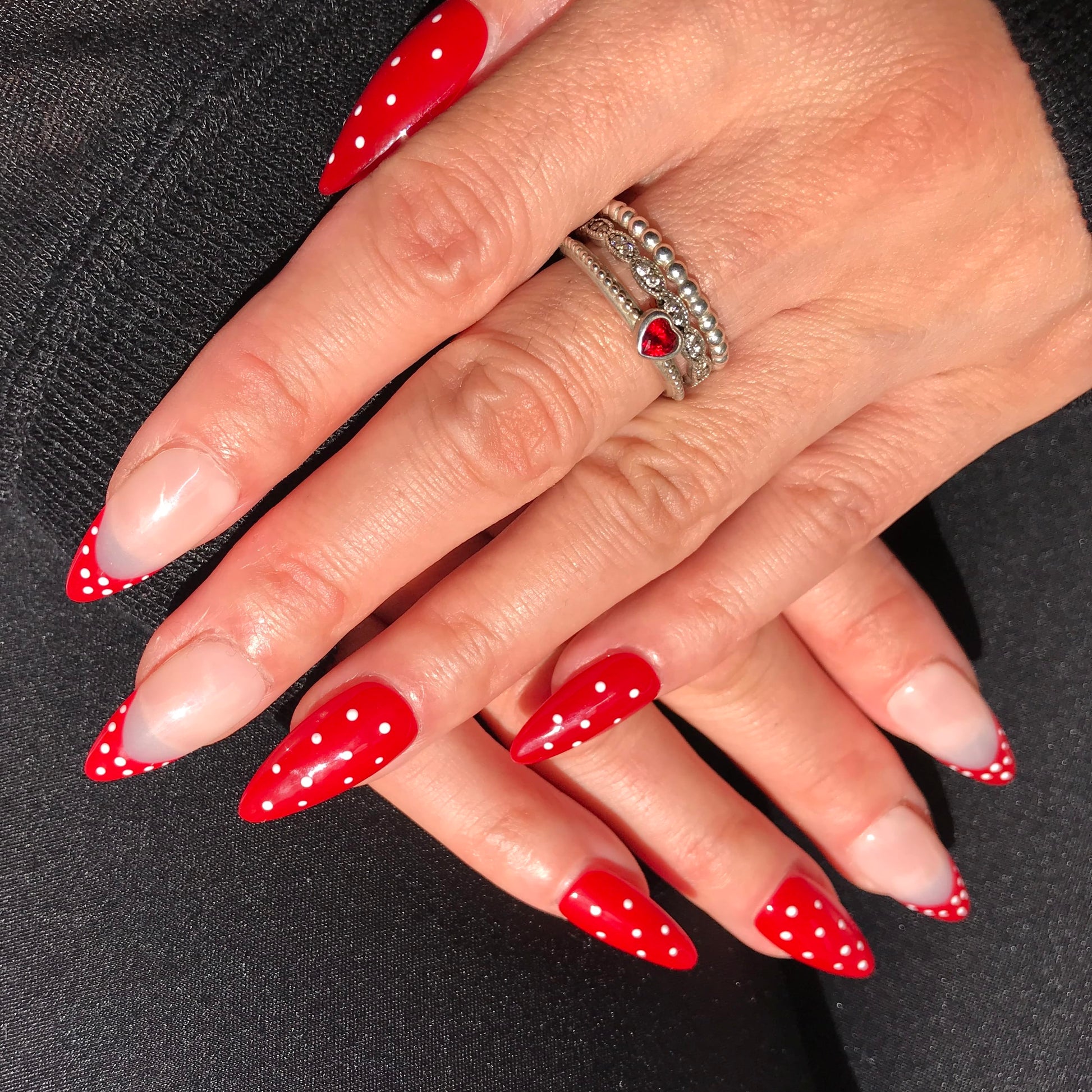 Luxury press-on nails, vintage Hollywood style, red almond with white polka dots. 