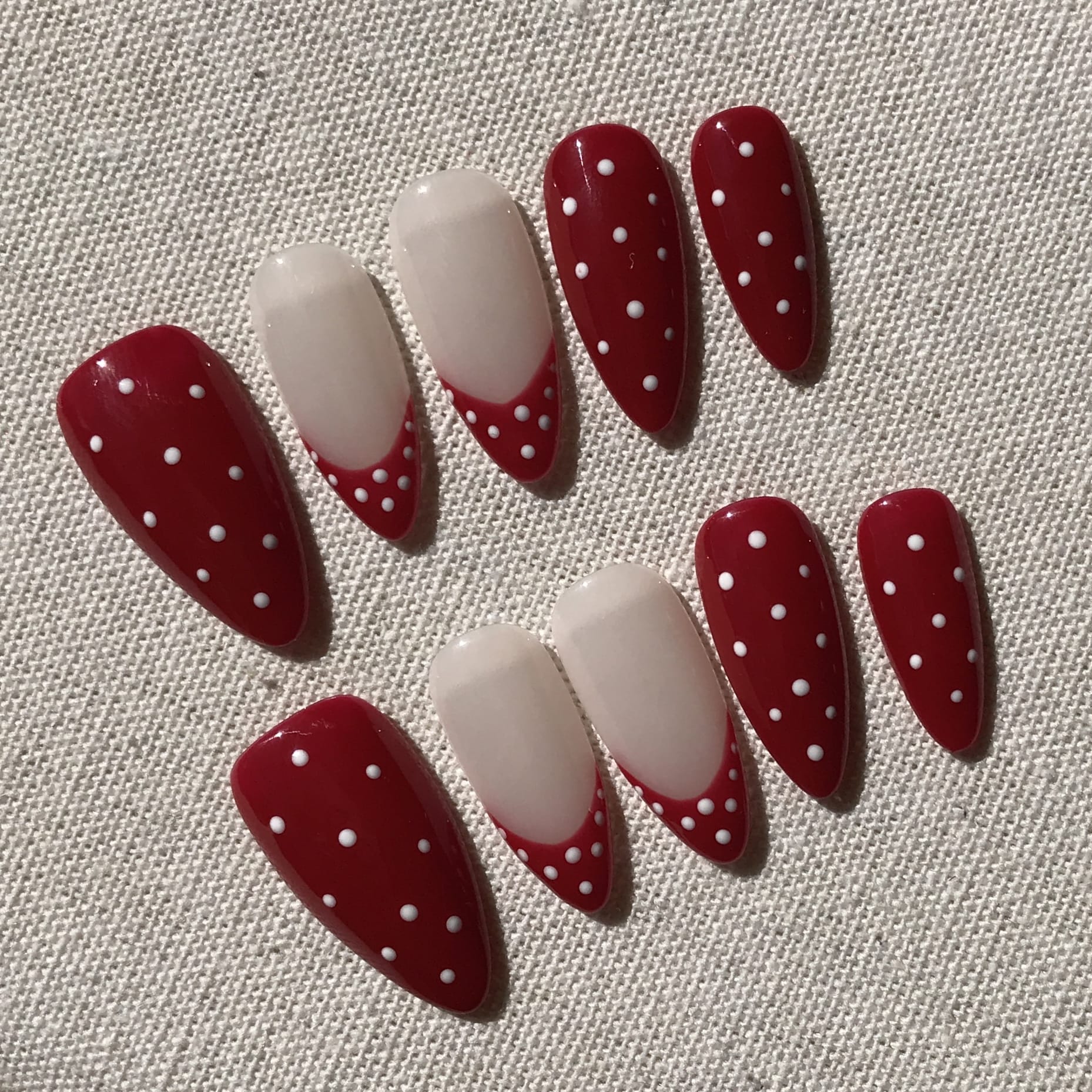 Calm Storm premium handmade press-on nails in red and white polka dot  design.
