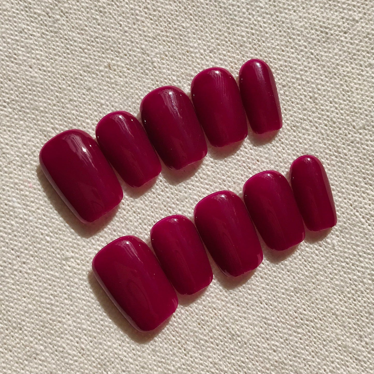 Calm Storm premium handmade press-on nails in deep magenta in extra short square. 