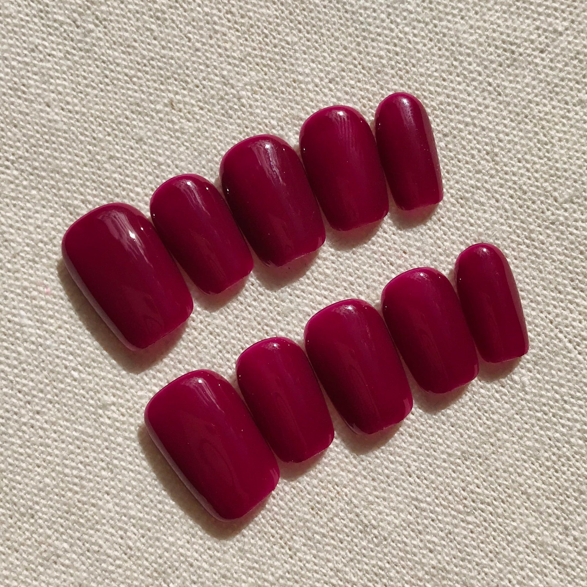 Calm Storm premium handmade press-on nails in deep magenta in extra short square. 