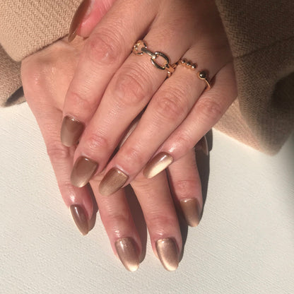 Luxury handmade toffee cat eye press on nails close up. 