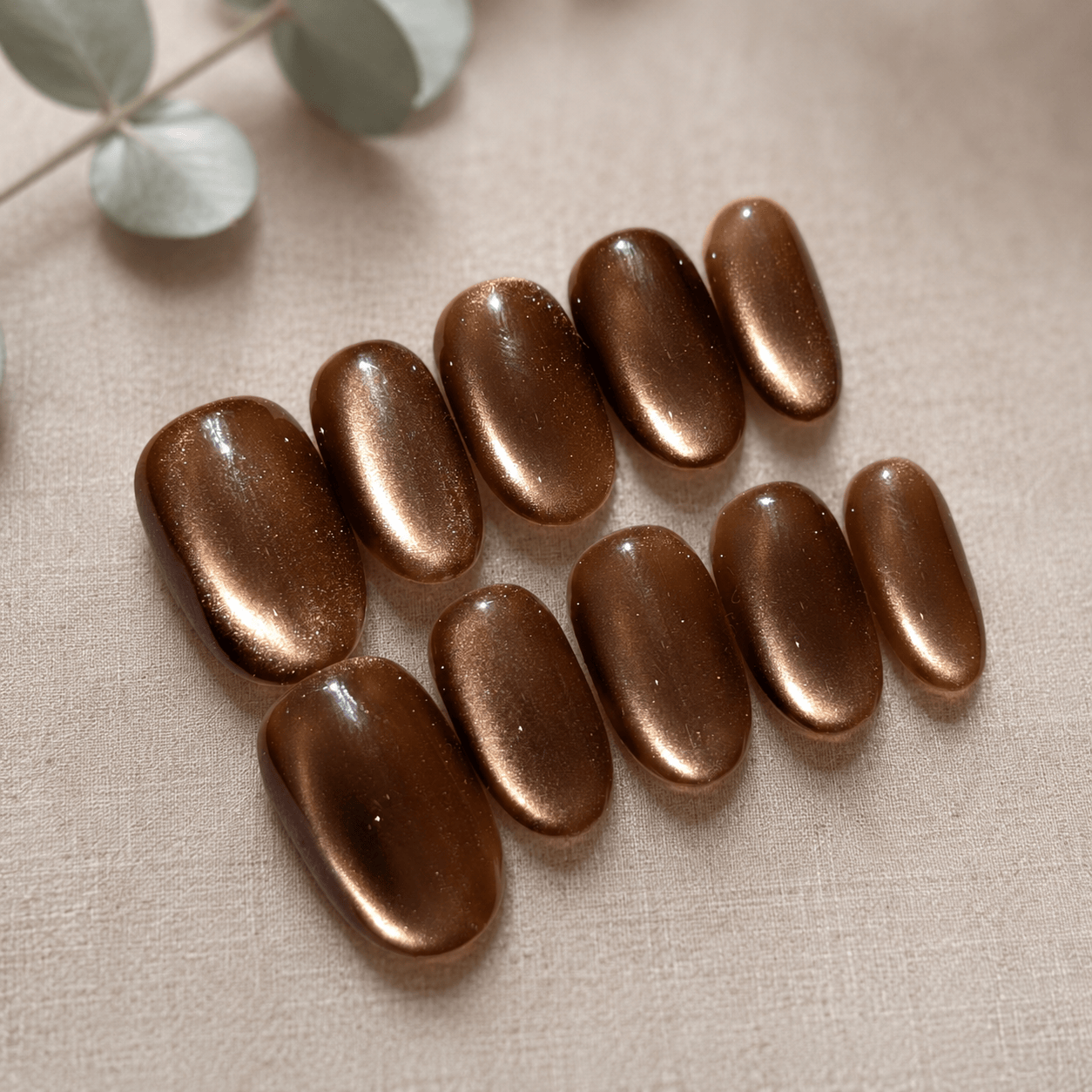 Calm Storm handmade press on nails brown with glittering cat eye design in oval shape. 