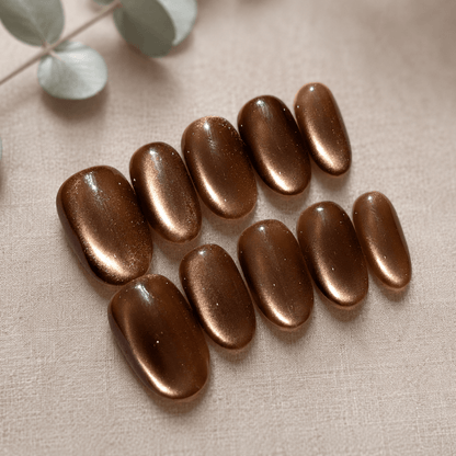 Calm Storm handmade press on nails brown with glittering cat eye design in oval shape. 