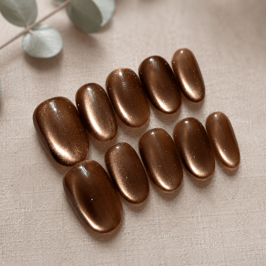 Calm Storm handmade press on nails brown with glittering cat eye design in oval shape. 