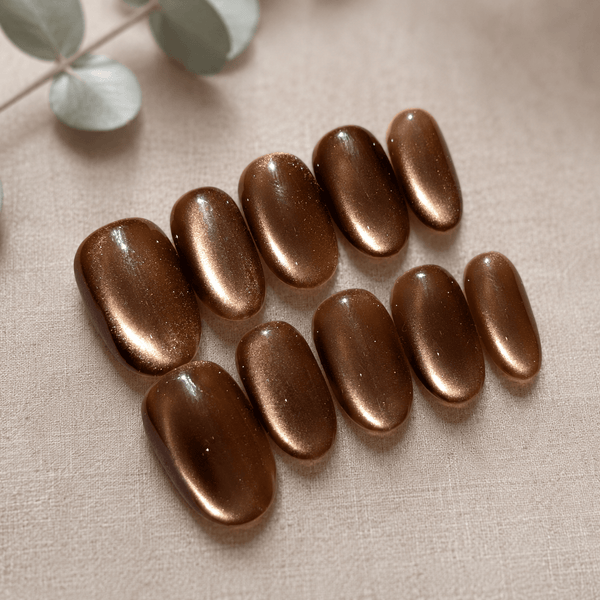 Calm Storm handmade press on nails brown with glittering cat eye design in oval shape. 